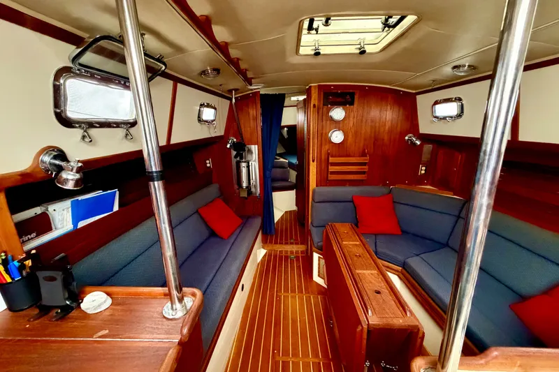 Slide: The Image of Interior of 1997 Pacific Seacraft Crealock 37 sailboat with wood finish and blue seating. - 13
