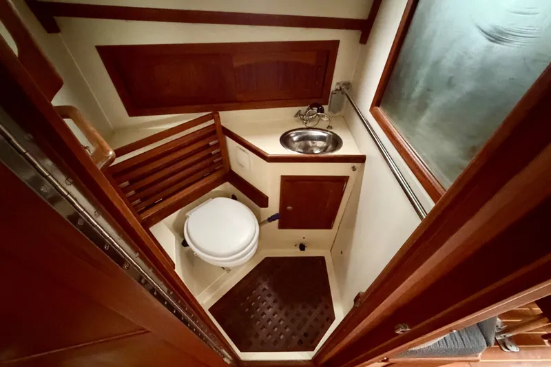 Slide: The Image of Interior of 1997 Pacific Seacraft Crealock 37 yacht bathroom with wooden accents and compact design. - 59