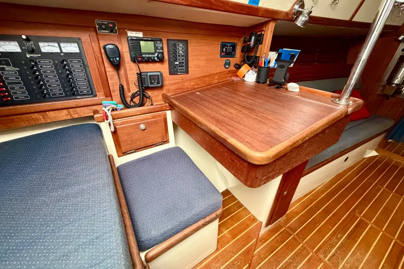 Slide: The Image of Navigation station of a 1997 Pacific Seacraft Crealock 37 sailboat with wooden interior. - 15