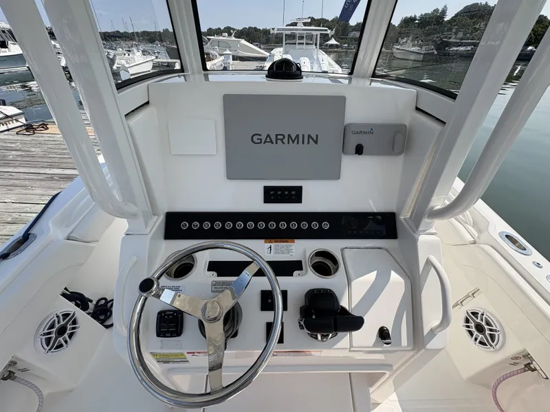 Slide: The Image of The image shows the helm of a Regulator 25 boat with a Garmin navigation system. - 29
