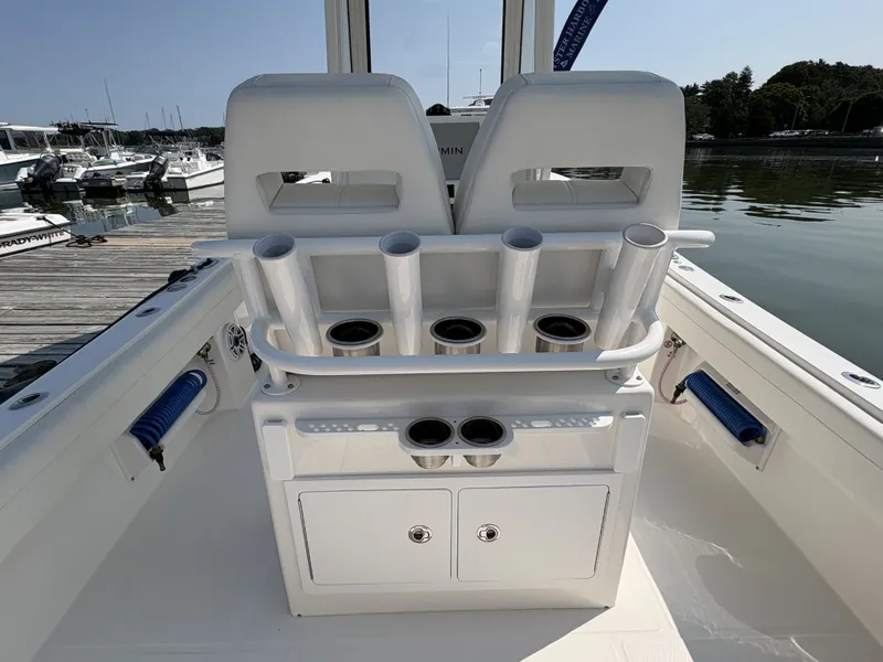 Slide: The Image of The image shows the cockpit of a Regulator 25 boat with rod holders and storage. - 20