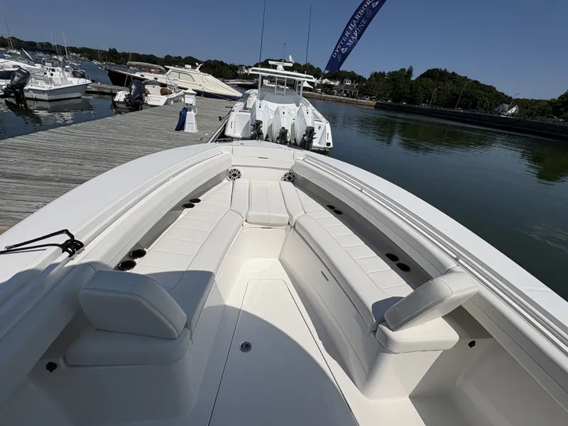 Slide: The Image of The image shows a modern boat with white upholstery docked at a pier. - 35