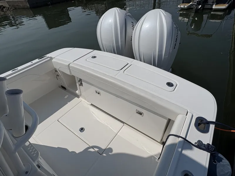 Slide: The Image of The image shows the stern of a Regulator 25 boat with two outboard engines. - 13