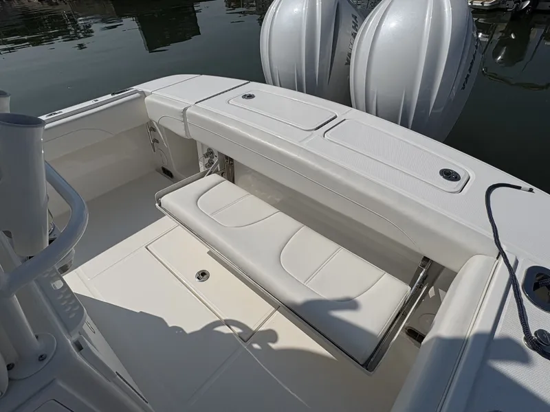 Slide: The Image of The image shows the cockpit of a Regulator 25 boat with a white bench seat and two engines. - 14