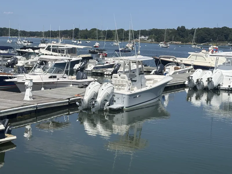 Slide: The Image of A 2025 Regulator 25 is docked in a busy marina with several other boats. - 7