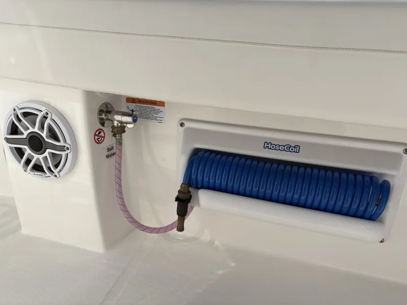 Slide: The Image of A speaker and a water hose are mounted on the white boat wall. - 24