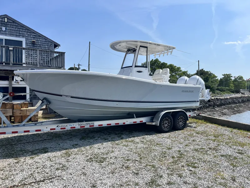 Slide: The Image of A 2025 Regulator 25 boat on a trailer beside a building. - 11