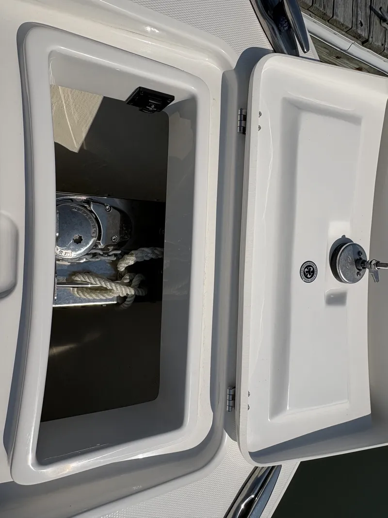 Slide: The Image of An open storage compartment on a boat with rope and anchor. - 47