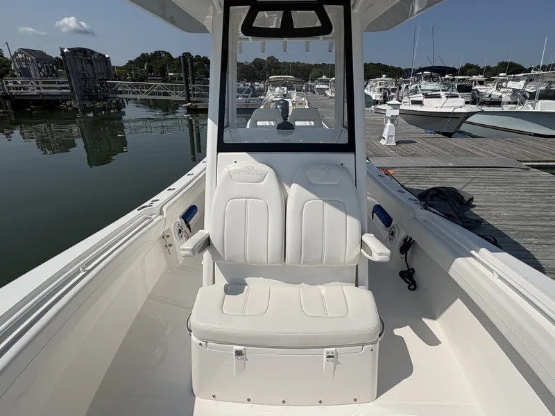 Slide: The Image of The image shows the cockpit of a 2025 Regulator 25 boat docked at a marina. - 36