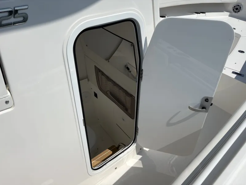 Slide: The Image of The 2025 Regulator 25 features an open door to a storage area or cabin. - 32
