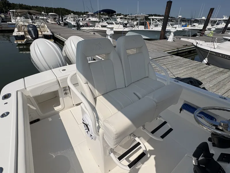 Slide: The Image of The image shows the cockpit of a Regulator 25 boat with white seats and a steering wheel. - 27