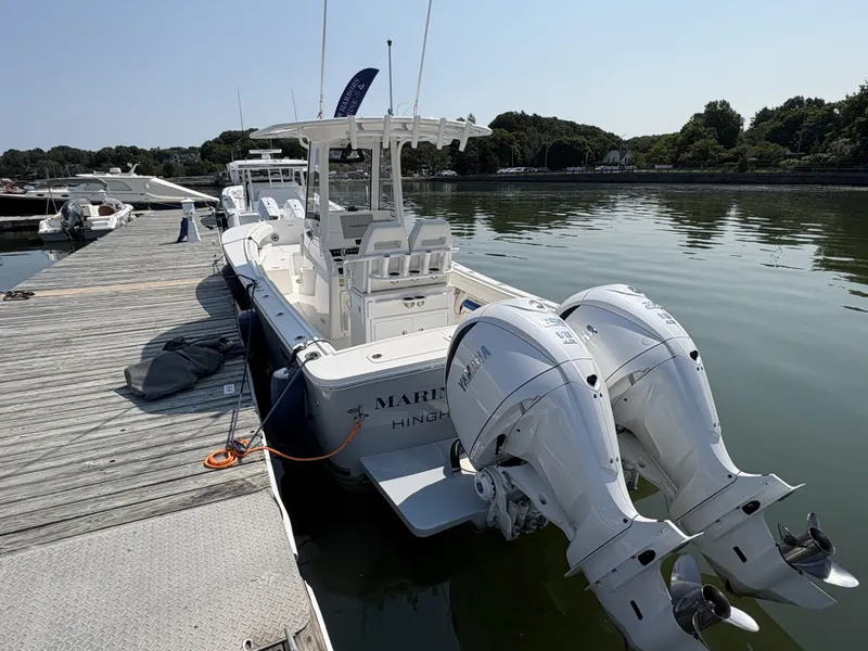 Slide: The Image of 2025 Regulator 25 at dock with twin outboard engines. - 12