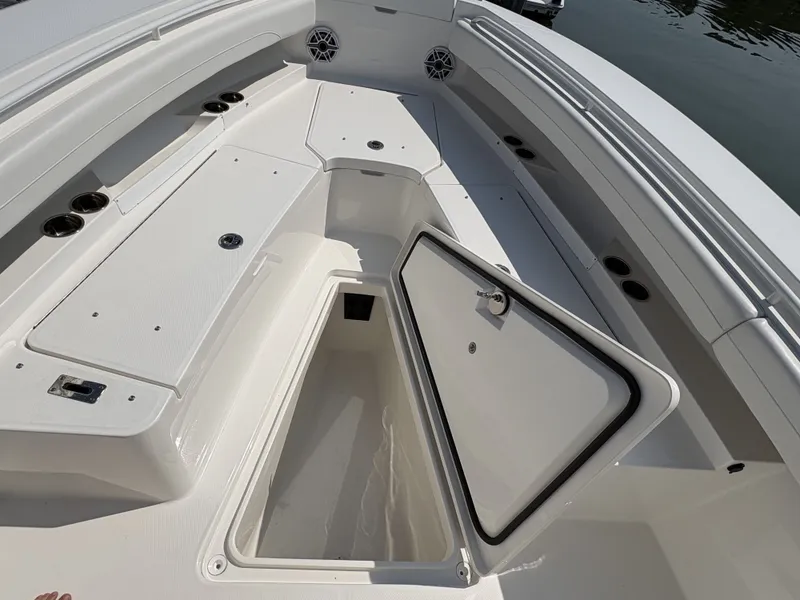 Slide: The Image of The image shows the deck of a Regulator 25 boat with an open storage compartment. - 40