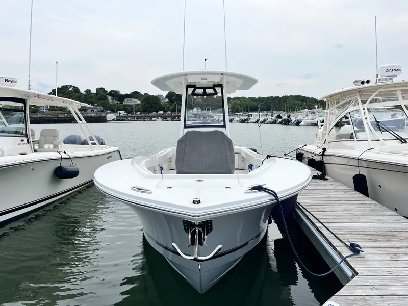 Slide: The Image of Regulator 25 from 2025 docked, surrounded by other boats, with calm water in the background. - 9