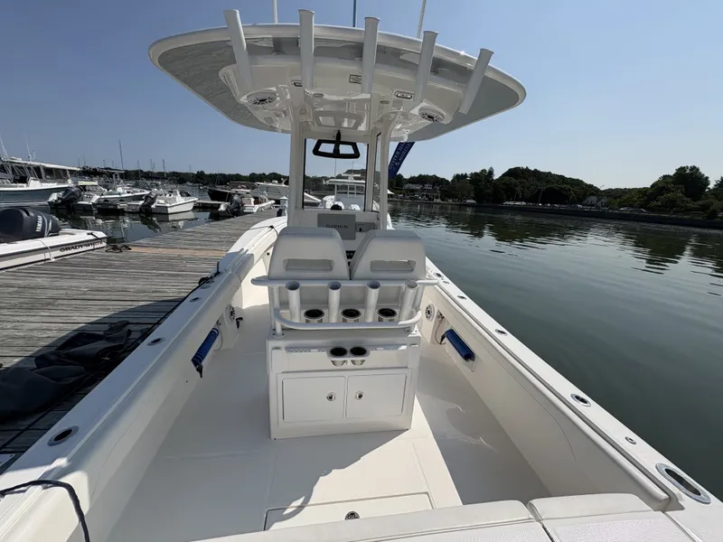 Slide: The Image of The image shows a modern boat with a spacious deck and sleek seating, docked at a marina. - 19