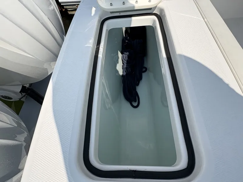 Slide: The Image of A storage compartment on a Regulator 25 boat with ropes inside. - 16