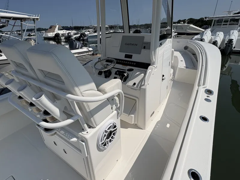Slide: The Image of The image shows the cockpit of a 2025 Regulator 25 boat with modern navigation systems. - 25