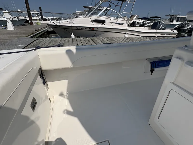 Slide: The Image of The image shows the cockpit of a 2025 Regulator 25 boat docked at a marina. - 18