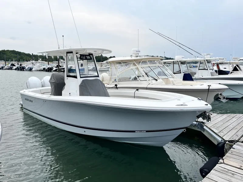 Slide: The Image of A modern 2025 Regulator 25 is docked at a marina. - 6