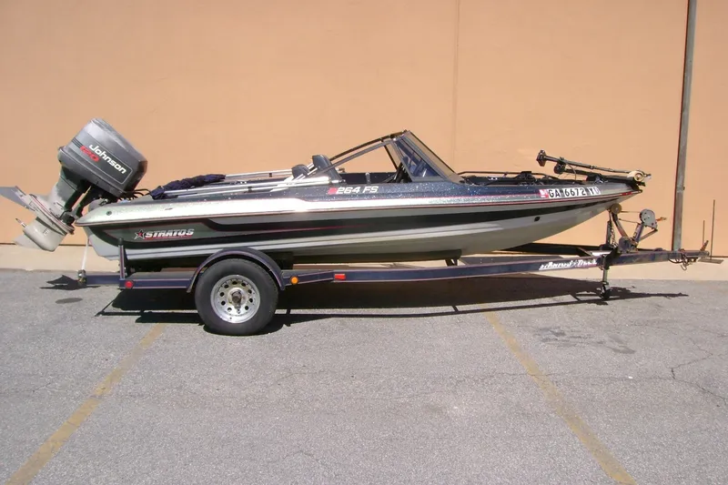 The Image of 1993 Stratos 264 Fish-N-Ski boat on trailer with Johnson outboard motor. - 1