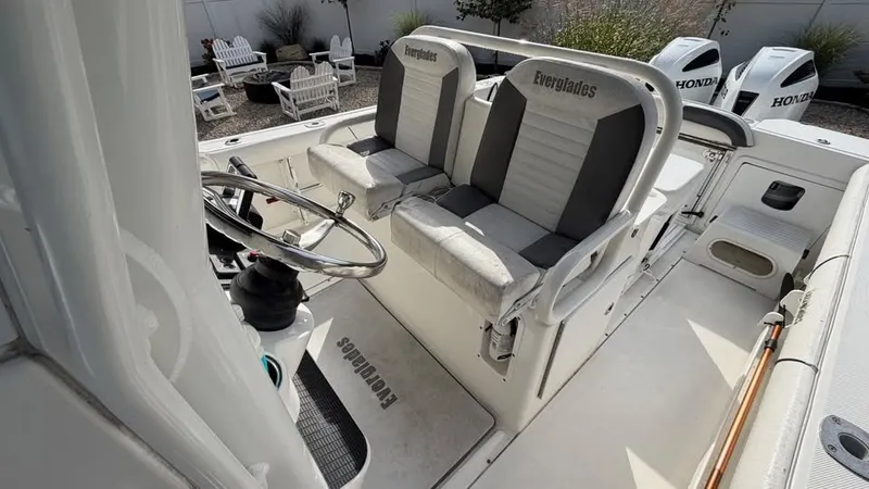 Slide: The Image of The image shows the cockpit of a 2007 Everglades 290 CC boat with two seats and steering. - 8