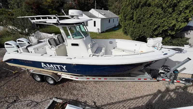 Slide: The Image of A 2007 Everglades 290 CC boat on a trailer in a yard. - 1