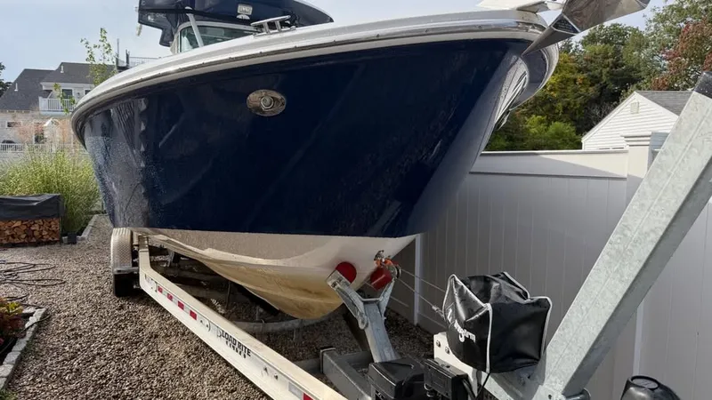 Slide: The Image of A blue Everglades 290 CC boat from 2007 is on a trailer in a yard. - 4