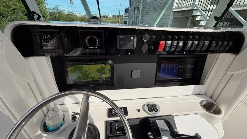 Slide: The Image of The image shows the helm of a 2007 Everglades 290 CC boat with modern instruments. - 10