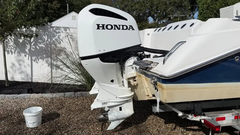 Slide: The Image of A Honda outboard motor is mounted on a 2007 Everglades 290 CC boat, sitting on a trailer. - 16