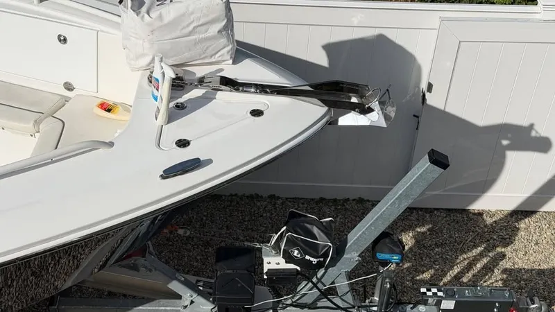 Slide: The Image of A 2007 Everglades 290 CC boat on a trailer, featuring an anchor and cover. - 14