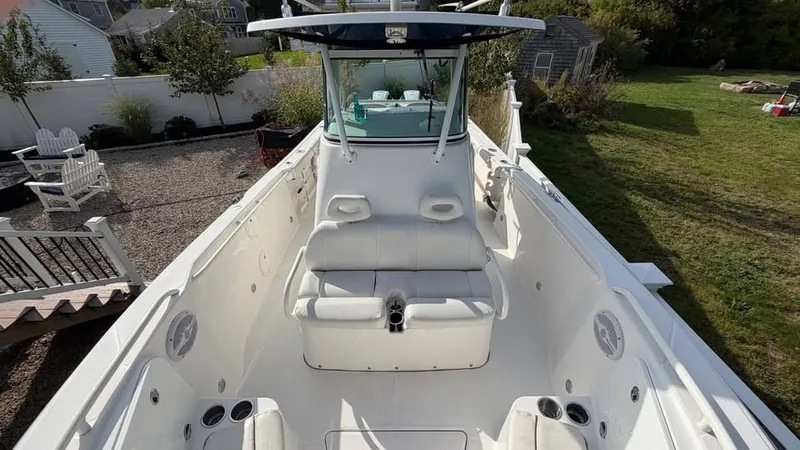 Slide: The Image of The image shows a 2007 Everglades 290 CC boat with white seating and a helm station. - 12
