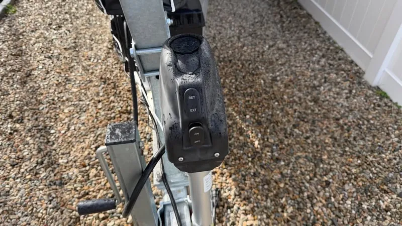 Slide: The Image of Close-up of a boat trailer with control buttons on a gravel surface. - 18