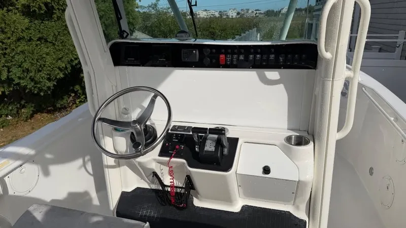 Slide: The Image of The image shows the helm of a 2007 Everglades 290 CC boat with a steering wheel and controls. - 9