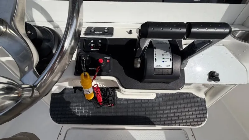 Slide: The Image of The image shows the helm of a 2007 Everglades 290 CC boat with steering wheel and controls. - 11