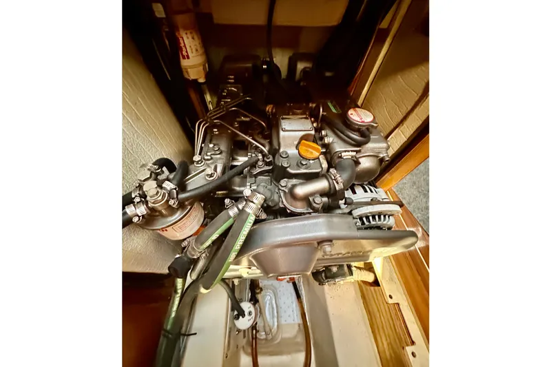 Slide: The Image of Engine compartment of a 2007 Hunter 41 Deck Salon sailboat, showcasing mechanical components. - 17