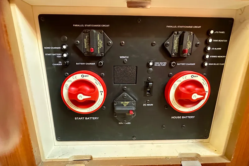 Slide: The Image of Control panel of a 2007 Hunter 41 Deck Salon sailboat, featuring battery switches and circuit controls. - 25