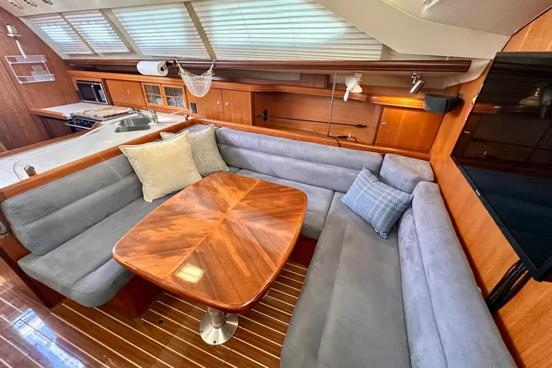 Slide: The Image of Luxurious interior of 2007 Hunter 41 Deck Salon with plush seating and elegant wood finishes. - 4