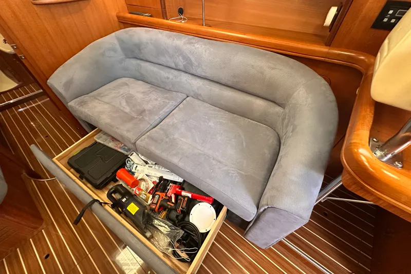 Slide: The Image of Interior of 2007 Hunter 41 Deck Salon with storage under blue sofa. - 5