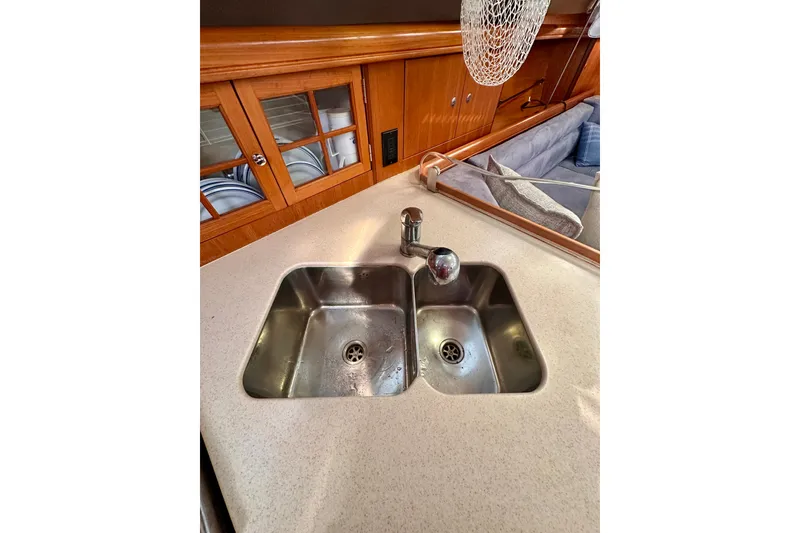 Slide: The Image of Galley sink in 2007 Hunter 41 Deck Salon yacht with wooden cabinetry. - 22