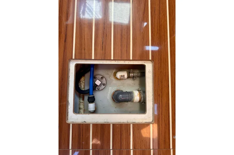 Slide: The Image of Access panel on 2007 Hunter 41 Deck Salon boat with visible plumbing components. - 15