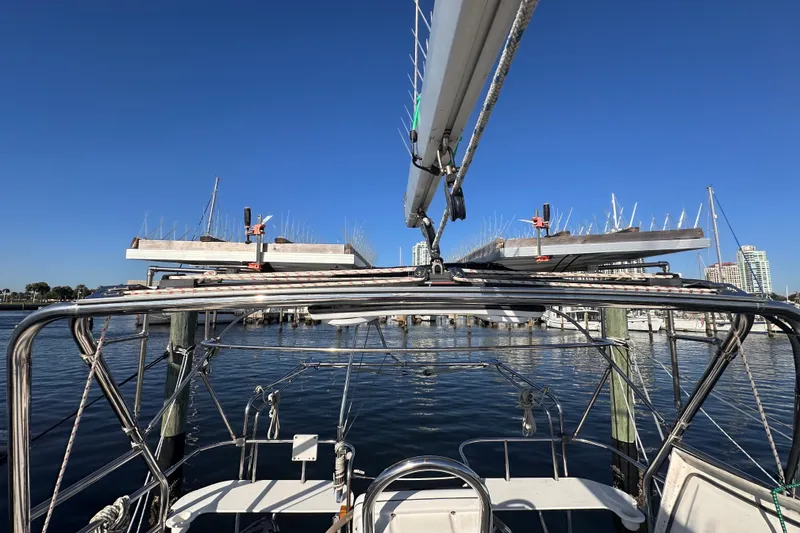 Slide: The Image of 2007 Hunter 41 Deck Salon sailboat docked at marina under clear blue sky. - 35