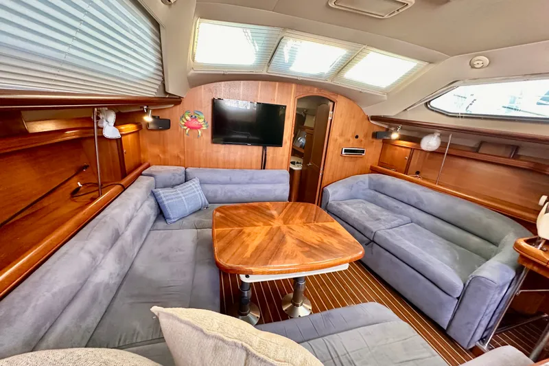 Slide: The Image of Luxurious interior of 2007 Hunter 41 Deck Salon with plush seating and wooden accents. - 32