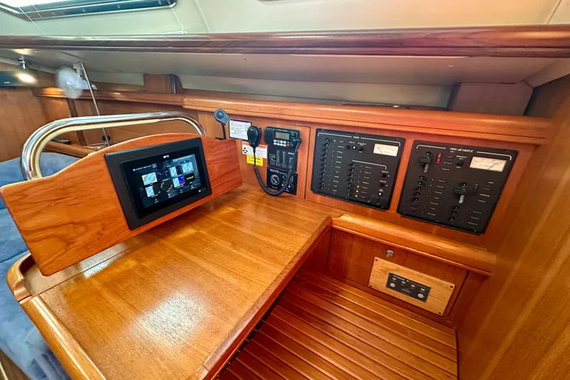 Slide: The Image of 2007 Hunter 41 Deck Salon navigation station with control panels and touchscreen display. - 27
