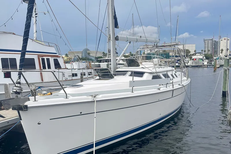 The Image of 2007 Hunter 41 Deck Salon sailboat docked in marina, clear sky background. - 0