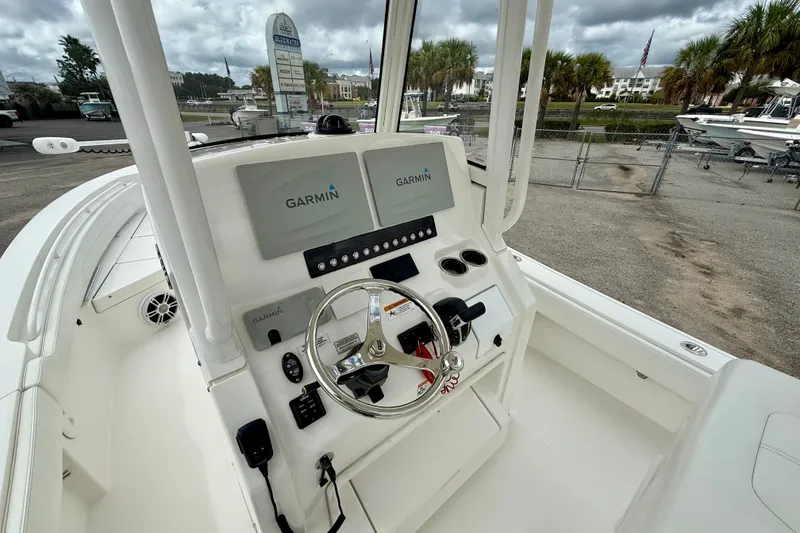 Slide: The Image of 2021 Regulator 24XO boat cockpit with Garmin navigation displays and steering wheel. - 14
