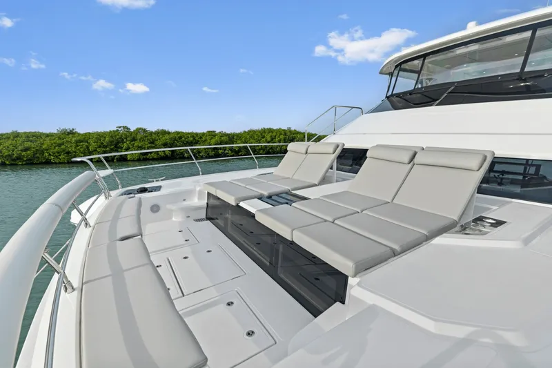 Slide: The Image of The image shows the deck of a 2027 Aquila 50 with luxurious loungers. - 44
