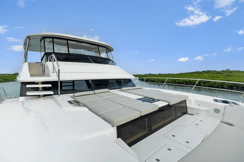 Slide: The Image of The 2027 Aquila 50 features a modern design with a spacious sun deck and panoramic windows. - 46