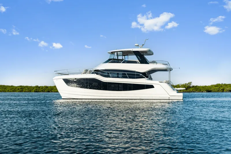 Slide: The Image of A modern 2027 Aquila 50 yacht on calm water under a blue sky. - 35