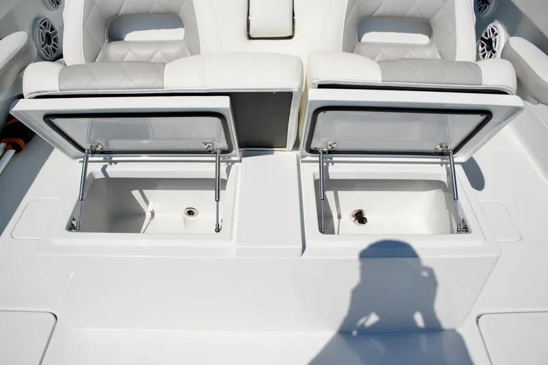 Slide: The Image of Open storage compartments on a 2024 Freeman 38 boat, featuring cushioned seating. - 21