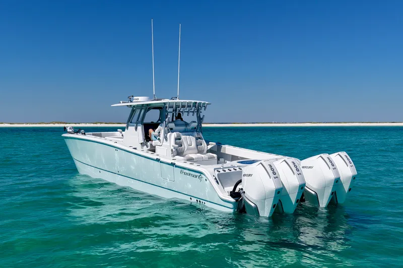 Slide: The Image of 2024 Freeman 38 boat with Mercury engines on clear turquoise water. - 6